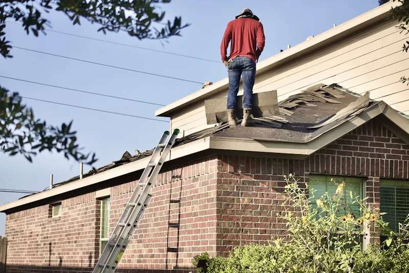Professional roofer working on a residential roof in Windstone
